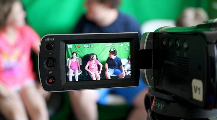 campers recording scene in front of greenscreen