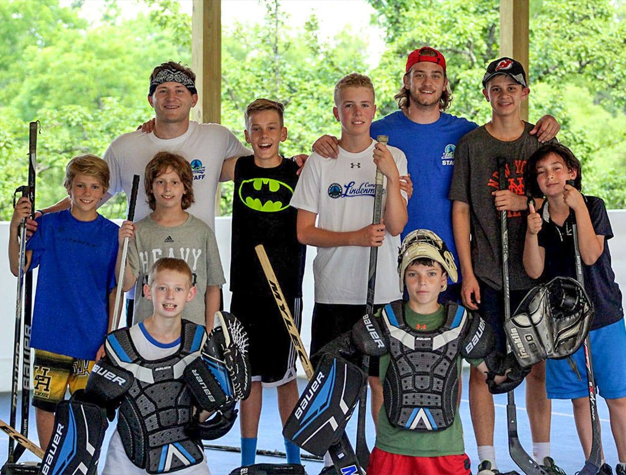 campers and staff with hockey equipment